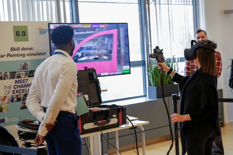 Woman using glasses of virtual reality in front of a TV screen and two men watching