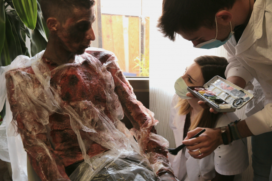 Students using makeup to create wound-like skin