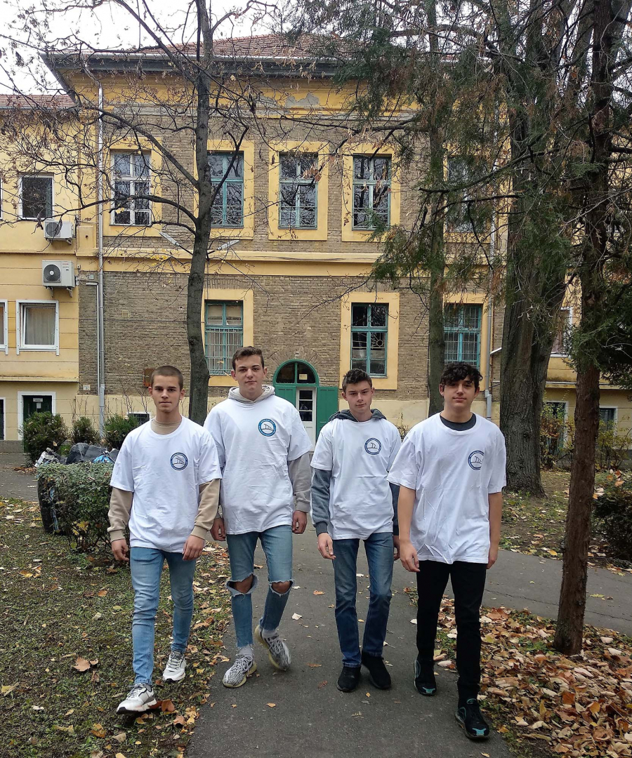 Young students with white t-shirts walking in front of a building