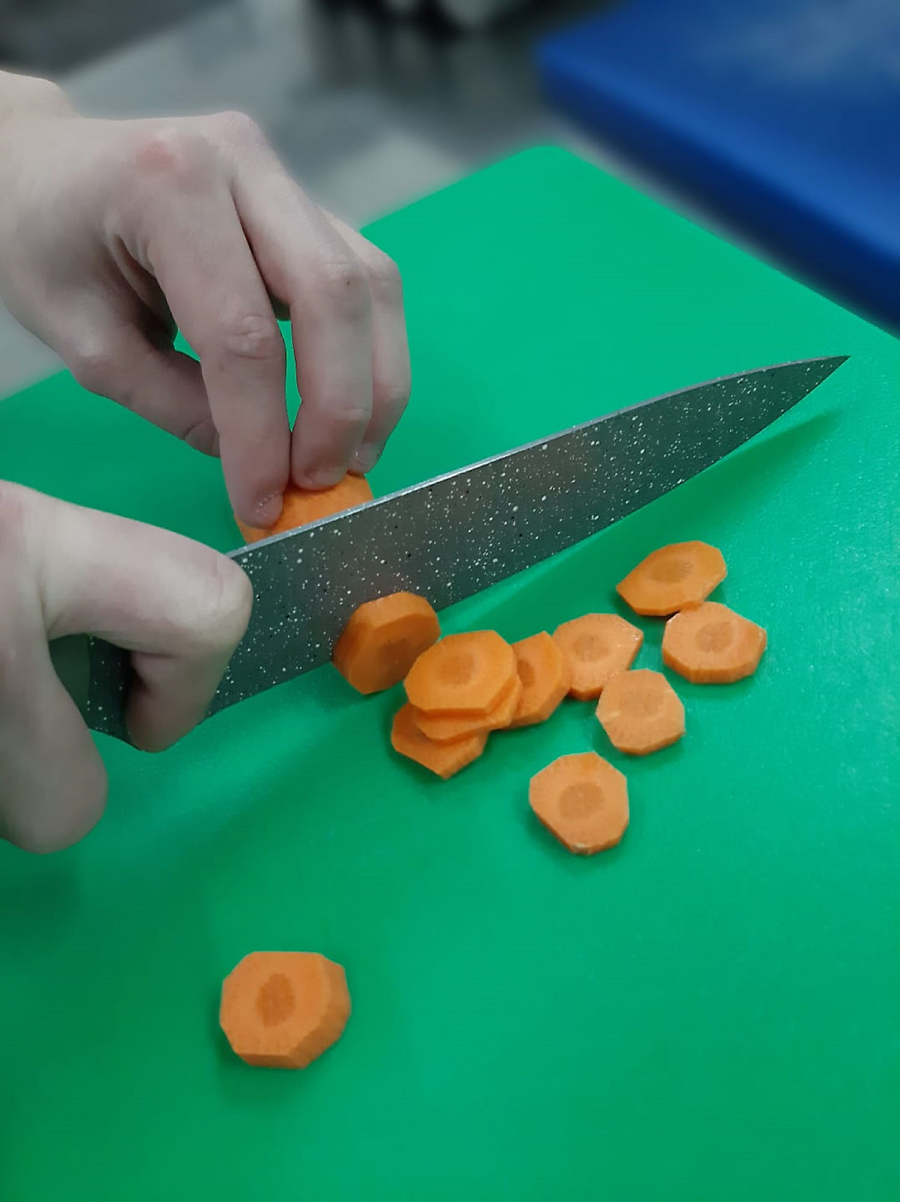  Close-up of chopping carrots