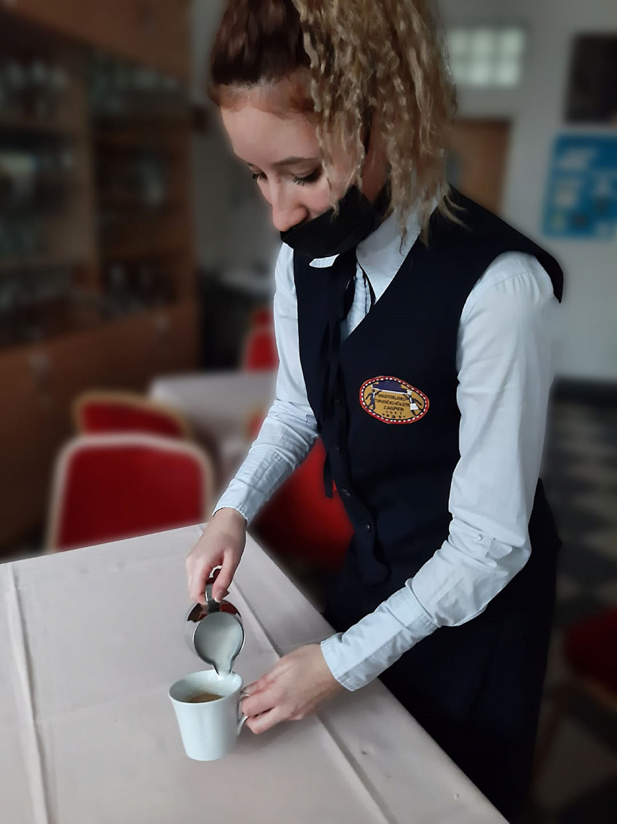 Waitress pouring coffee in a cup