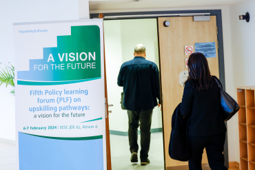 Banner, two people entering a conference room